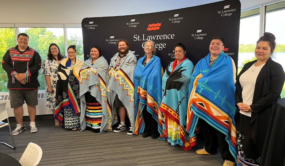 SLC staff and graduates with the blankets they received at the Indigenous pre-convocation ceremony